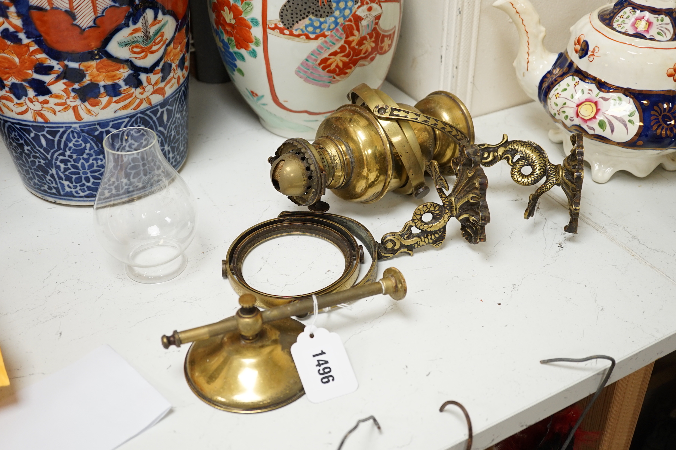 A pair of brass ship design lanterns with glass shades